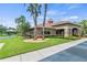 Community clubhouse with stone accents, tiled roof, well-maintained landscaping, and a nearby playground at 1628 Thetford Cir, Orlando, FL 32824