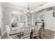Charming dining room showcases hardwood floors, an elegant light fixture, and seamless transition to the living room at 1628 Thetford Cir, Orlando, FL 32824