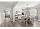 Elegant dining room boasts hardwood floors, modern lighting, and seamless transition to the living room at 1628 Thetford Cir, Orlando, FL 32824