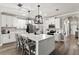 Bright kitchen features a large center island, white cabinets, stainless steel appliances, and pendant lighting at 1628 Thetford Cir, Orlando, FL 32824