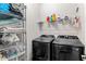 Organized laundry room with modern appliances, ample storage, and efficient layout for convenient chores at 1628 Thetford Cir, Orlando, FL 32824