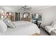 Comfortable bedroom featuring a ceiling fan, TV, dresser, and cozy chair, perfect for relaxation and entertainment at 1628 Thetford Cir, Orlando, FL 32824