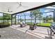 Enclosed lanai boasts beautiful lake views, comfortable seating, ceiling fans, and a brick-paved floor at 1628 Thetford Cir, Orlando, FL 32824