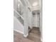 Elegant staircase features white railings, hardwood floors, and leads to the upper level at 1628 Thetford Cir, Orlando, FL 32824