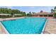 Large swimming pool with clear blue water, surrounded by comfortable lounging areas, ideal for relaxation and recreation at 1628 Thetford Cir, Orlando, FL 32824