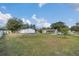 Expansive backyard with lush green grass, mature trees, and plenty of open space at 18302 15Th Ave, Orlando, FL 32833