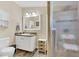 Well-lit bathroom with a vanity, framed mirror, shower with glass door, and wood plank-style floors at 18302 15Th Ave, Orlando, FL 32833