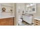 This bathroom has a white vanity with cultured marble countertop, drawers, and a wall mirror at 18302 15Th Ave, Orlando, FL 32833