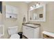 This bathroom features a white vanity with cultured marble countertop and a wall mirror at 18302 15Th Ave, Orlando, FL 32833