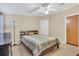 This cozy bedroom has wood-look flooring, neutral paint, and modern ceiling fan with light at 18302 15Th Ave, Orlando, FL 32833