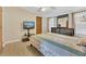 This bedroom has a TV, wood-look flooring, and neutral paint, creating a relaxed atmosphere at 18302 15Th Ave, Orlando, FL 32833