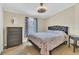 Serene bedroom with hardwood floors, a queen bed, neutral walls, and a stylish dresser at 18302 15Th Ave, Orlando, FL 32833