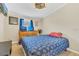 Inviting bedroom with wood floors, matching blue bedding, and functional desk for work or study at 18302 15Th Ave, Orlando, FL 32833