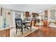 Inviting dining area with dark wood table and chairs, bright window, and hardwood floors at 18302 15Th Ave, Orlando, FL 32833