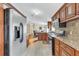 Modern kitchen featuring stainless steel appliances, wood cabinetry, and an adjacent dining area at 18302 15Th Ave, Orlando, FL 32833