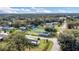 Wide aerial view of the community surrounded by beautiful mature trees and blue skies at 18302 15Th Ave, Orlando, FL 32833