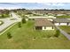 Aerial view of a home with a well-maintained lawn and screened-in porch at 1924 Piedmont Ct, Mascotte, FL 34753