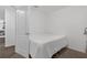 Minimalist bedroom with white walls and space for a bed in a bright, neutral space at 1924 Piedmont Ct, Mascotte, FL 34753