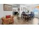 Open-concept dining area with elegant chandelier, a dining set, and hardwood floors, blending comfort and sophistication at 1924 Piedmont Ct, Mascotte, FL 34753