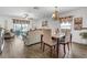 Open-concept living space with a dining area, couch, a ceiling fan and access to the backyard at 1924 Piedmont Ct, Mascotte, FL 34753