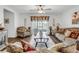 Inviting living room featuring stylish furniture, ceiling fan, and sliding glass doors to the lanai at 1924 Piedmont Ct, Mascotte, FL 34753