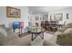 Inviting living room with couches, chair, an area rug, a dining area and an entertainment center in a light color palette at 1924 Piedmont Ct, Mascotte, FL 34753