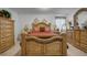 Spacious main bedroom featuring ornate wood furniture including a bed, dressers, nightstands and decor at 1924 Piedmont Ct, Mascotte, FL 34753