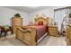 Spacious main bedroom featuring ornate wood furniture including a bed, dressers, nightstands and decor at 1924 Piedmont Ct, Mascotte, FL 34753