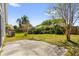 The backyard features green grass and a small concrete patio space at 205 Twisting Trl, Orlando, FL 32825