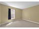 Empty bedroom with neutral carpet and a window with dark curtains at 205 Twisting Trl, Orlando, FL 32825