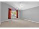 Empty bedroom with vaulted ceiling, fan, and a window overlooking the yard at 205 Twisting Trl, Orlando, FL 32825