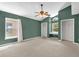 Large bedroom with olive colored walls, vaulted ceiling with fan, and closets at 205 Twisting Trl, Orlando, FL 32825