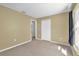 Empty bedroom with neutral carpet, doorway, closet and a window with light at 205 Twisting Trl, Orlando, FL 32825