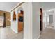 Open-concept kitchen featuring modern appliances, wooden cabinets, and tile flooring with adjacent archway at 205 Twisting Trl, Orlando, FL 32825