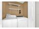 Functional laundry room with a washer, dryer, and wire shelving for storage at 205 Twisting Trl, Orlando, FL 32825