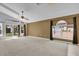 Spacious living room with high ceilings, carpet flooring, ceiling fan, and sliding glass doors to the backyard at 205 Twisting Trl, Orlando, FL 32825