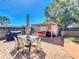 Inviting brick patio with an outdoor seating area, grill, and a storage shed under a clear blue sky at 2342 Linda St, Lake Wales, FL 33898