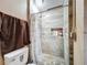 Bathroom featuring a shower stall with new tile work, toilet, new fixtures, and a ceiling light at 2342 Linda St, Lake Wales, FL 33898