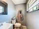 Compact bathroom with a white sink, toilet, and functional layout at 2342 Linda St, Lake Wales, FL 33898