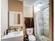 This is a bathroom with a toilet, shower stall, vanity, mirror, and a tile shower at 2342 Linda St, Lake Wales, FL 33898