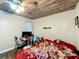 This is a bedroom with a ceiling fan, wood-like floors, multiple pictures hanging on the walls, and a small desk at 2342 Linda St, Lake Wales, FL 33898