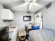 Bedroom featuring a door to the backyard, window, flatscreen TV, cabinets and a kitchenette at 2342 Linda St, Lake Wales, FL 33898