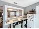 Stylish dining area with a view to the living room, bar seating, and a modern refrigerator at 2342 Linda St, Lake Wales, FL 33898