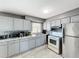Well-lit kitchen features gray cabinets, stainless steel appliances, and a decorative backsplash at 2342 Linda St, Lake Wales, FL 33898