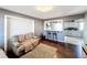 Inviting living room with hardwood floors, a modern light fixture, and an open view to the kitchen at 2342 Linda St, Lake Wales, FL 33898