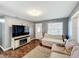 Comfortable living room featuring a large TV, sofa, and a decorative fireplace at 2342 Linda St, Lake Wales, FL 33898