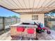 Outdoor bar area with a tile bar, two barstools, red lawn mower, and fence at 2342 Linda St, Lake Wales, FL 33898