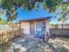 This backyard storage shed has a bike, patio furniture and provides extra storage at 2342 Linda St, Lake Wales, FL 33898
