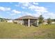 Aerial view of home featuring a well-maintained lawn and screened-in back patio at 2451 Spring Breeze Dr, Leesburg, FL 34748