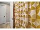 Bathroom featuring a bright, patterned shower curtain and tiled flooring at 2451 Spring Breeze Dr, Leesburg, FL 34748